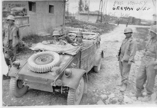 Americans posing with Nazi Jeep